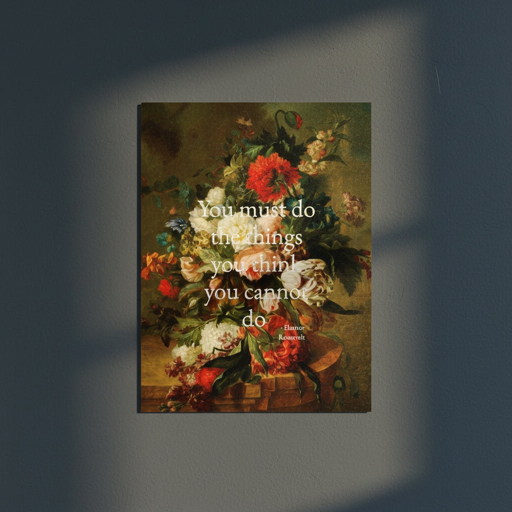 Floral still life painting with a motivational quote in gold metallic foil text hanging on blue-gray background with sunlight beaming in on it. 